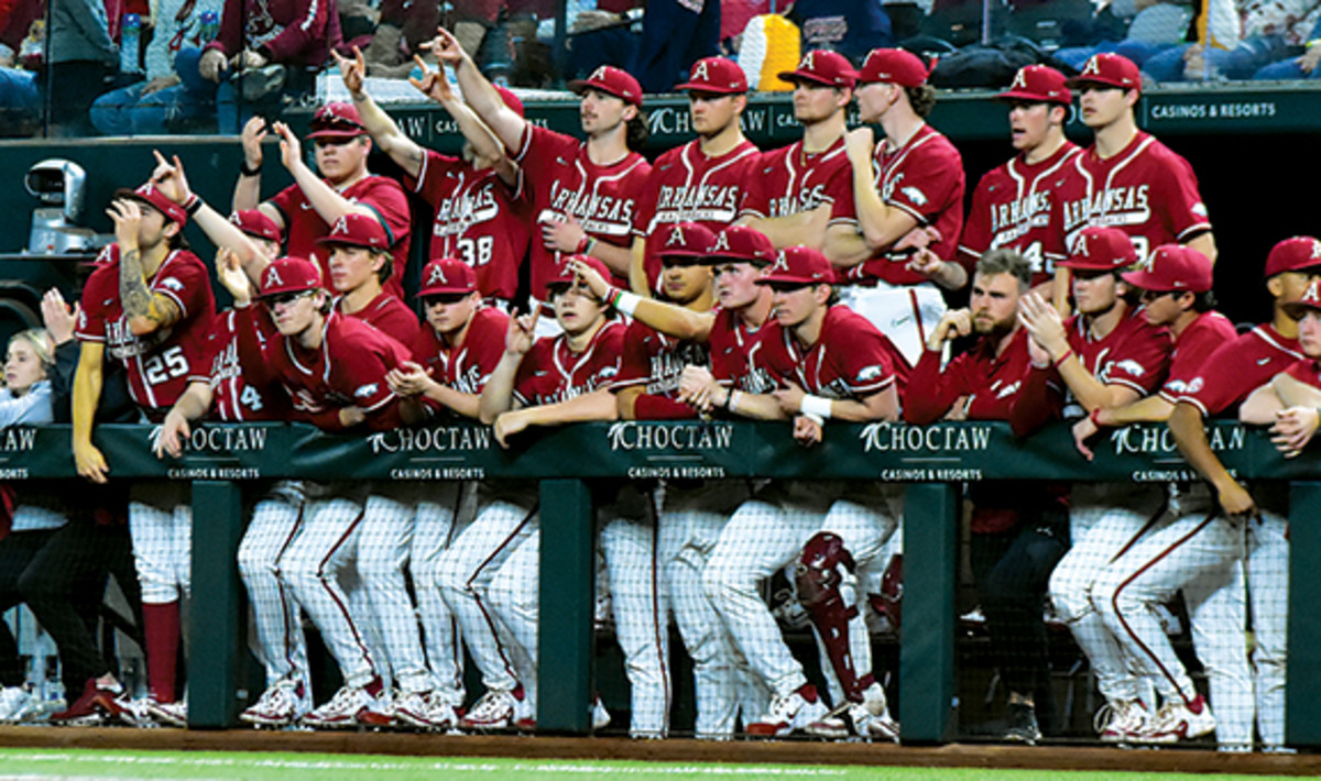 Members of the Arkansas baseball team throw up what looks a a Horns sign during their game with TCU.