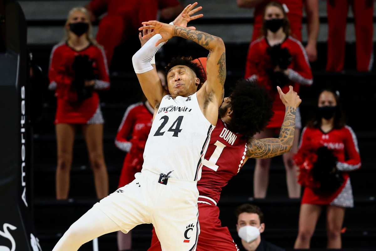Cincinnati Bearcats guard Jeremiah Davenport (24) and Temple Owls guard Damian Dunn (1) compete for a rebound in the second half of an NCAA men's college basketball game, Friday, Feb. 12, 2021, at Fifth Third Arena in Cincinnati. The Cincinnati Bearcats won, 71-69. Temple Owls At Cincinnati Bearcats Feb 12