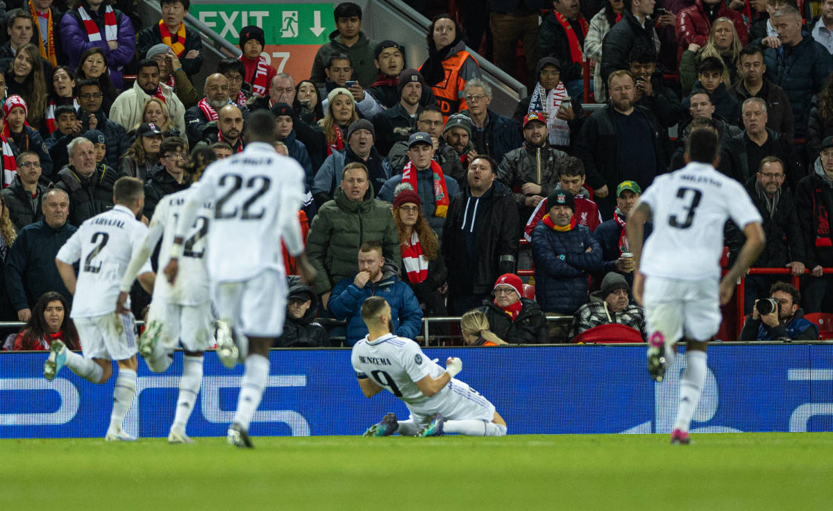 Karim Benzema pictured (center) sliding on his knees to celebrate a goal during Real Madrid's win over Liverpool at Anfield in February 2023