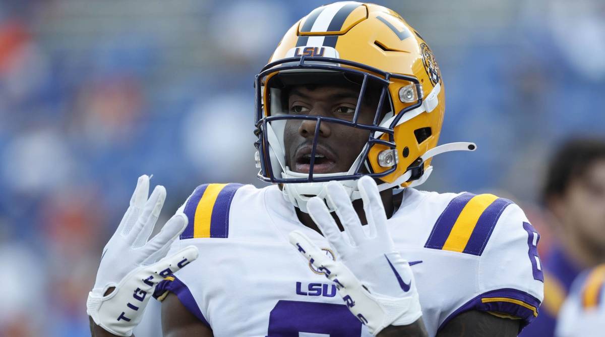 LSU wide receiver Malik Nabers holds up four fingers on each hand during a game.