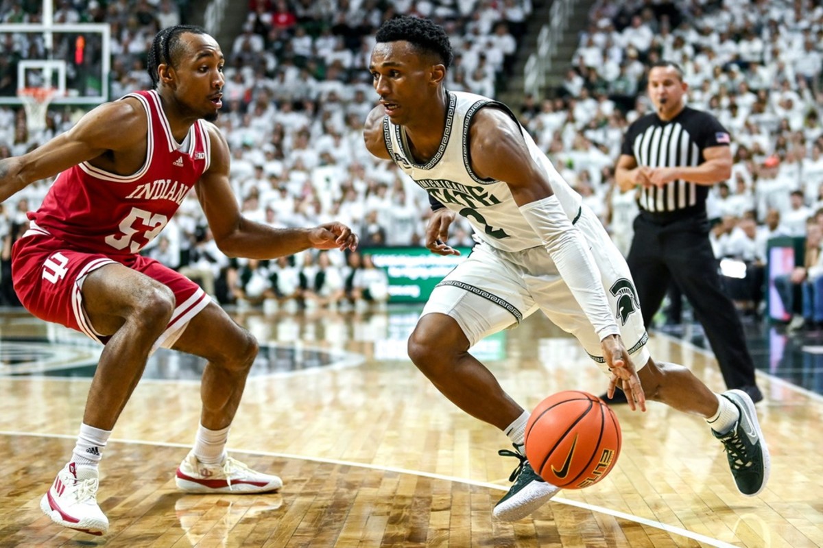Michigan State's Tyson Walker tries to drive past Indiana's Tamar Bates.