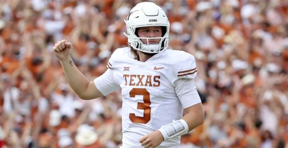 Texas Longhorns quarterback Quinn Ewers celebrates a play during a college football game.