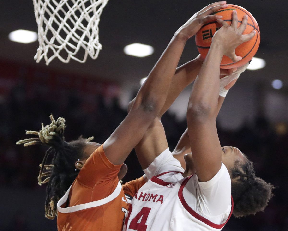Liz Scott (right) gets blocked at the rim.