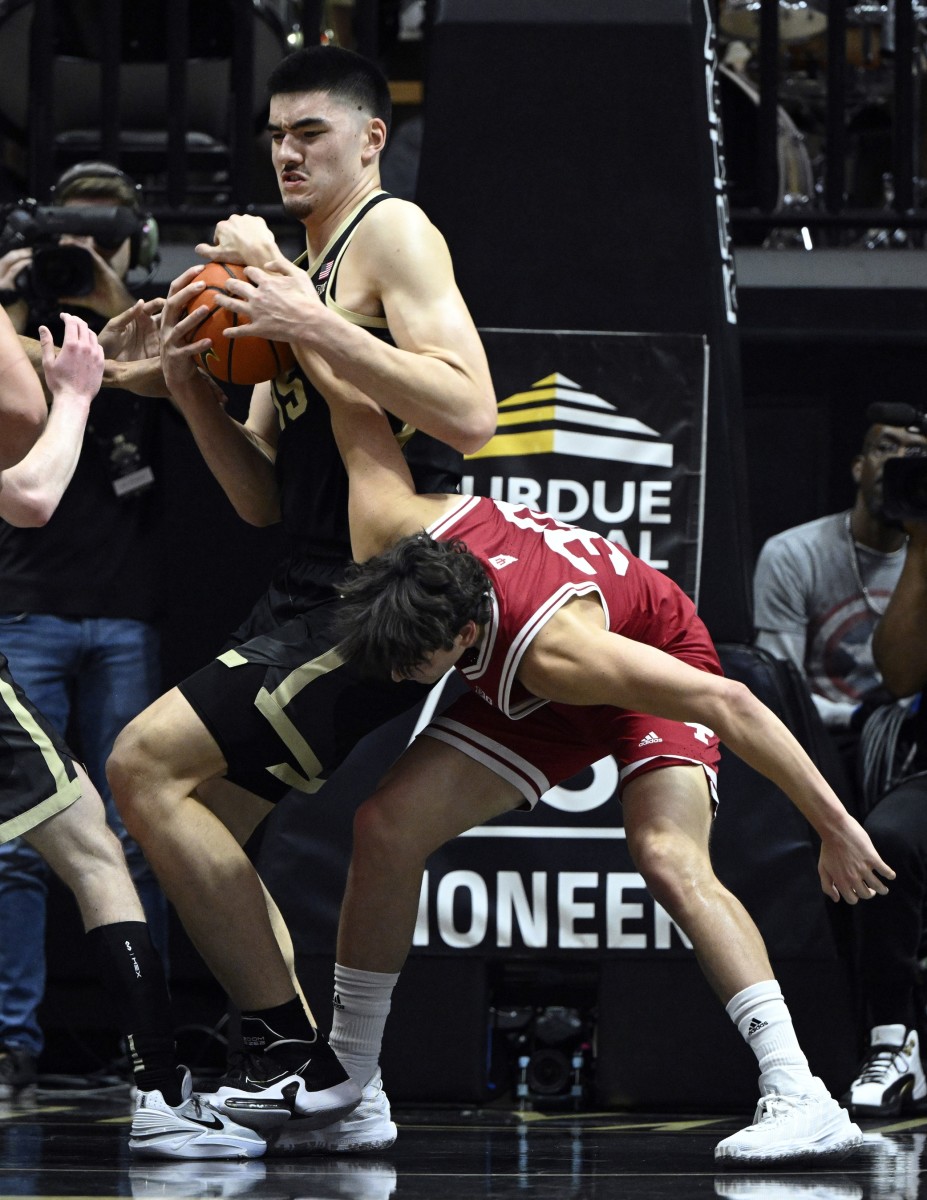 Purdue Boilermakers center Zach Edey (15) and Indiana Hoosiers guard Trey Galloway (32) fight for a rebound during the first half at Mackey Arena.