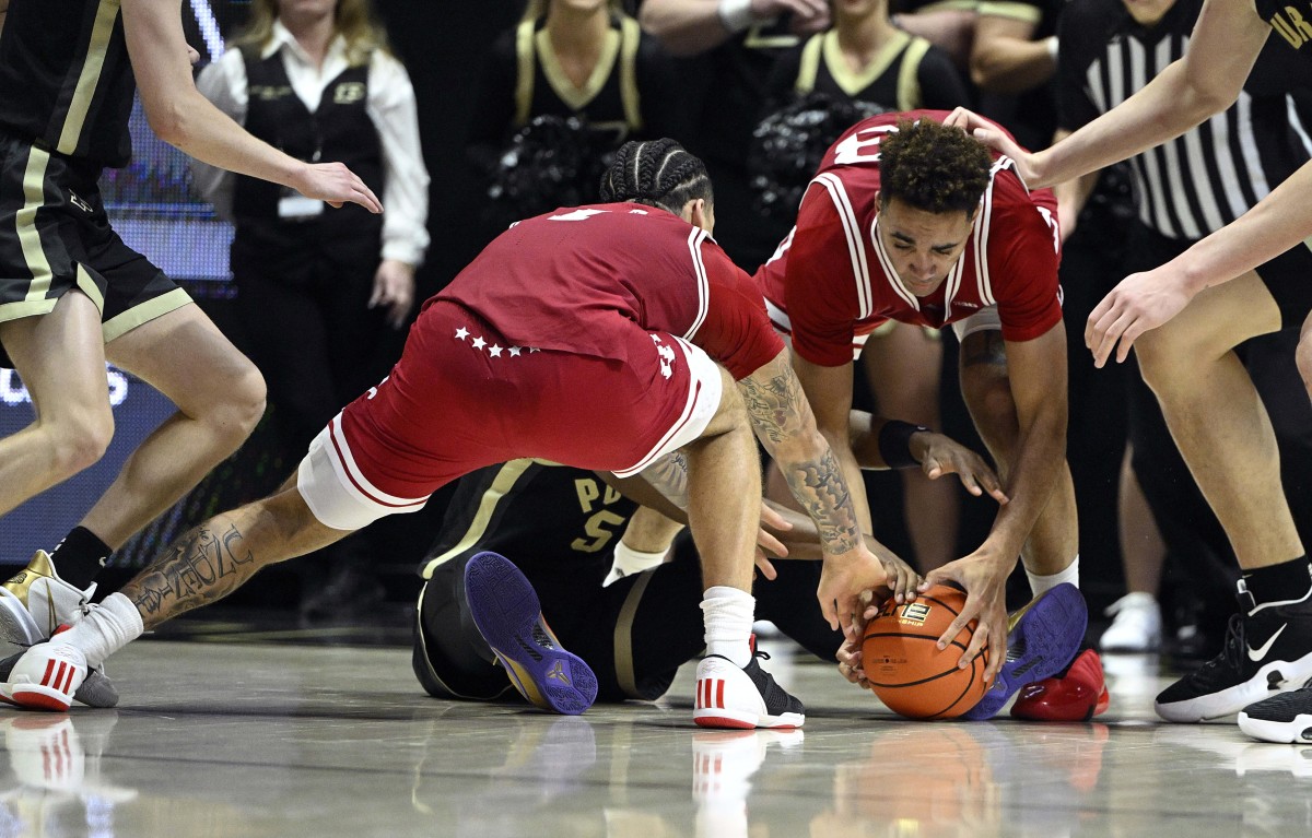 Jalen Hood-Schifino (left) and forward Trayce Jackson-Davis (right) battle for a loose ball against Purdue Boilermakers guard Brandon Newman (5) during the second half at Mackey Arena.