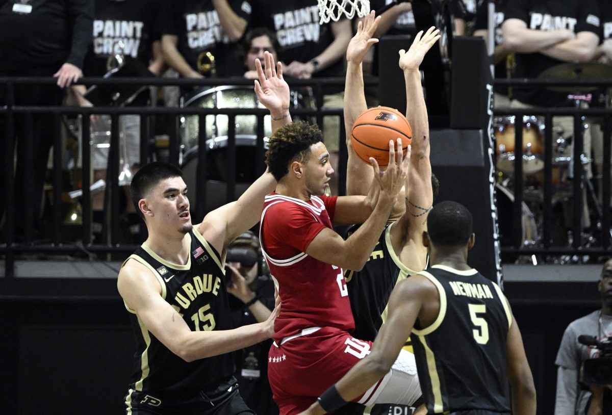 Indiana Hoosiers forward Trayce Jackson-Davis (23) jumps up with the ball against Purdue Boilermakers center Zach Edey (15) and forward Mason Gillis.