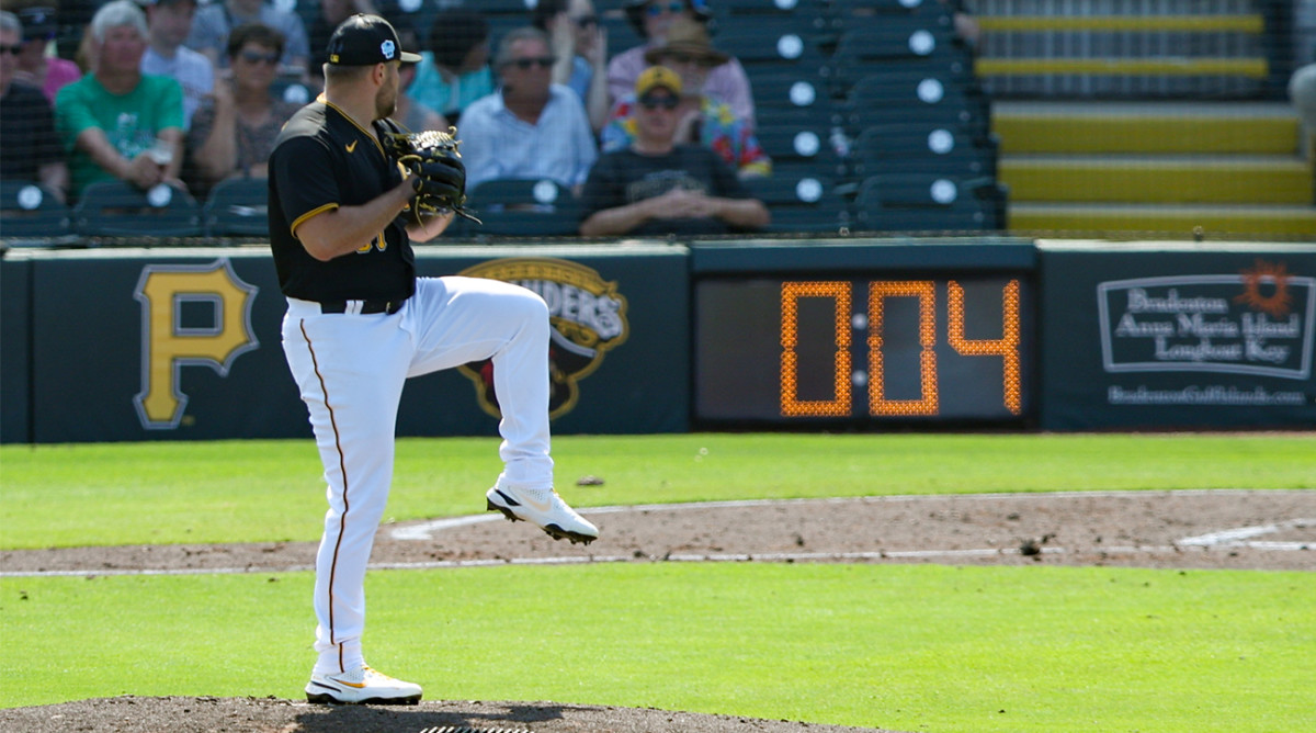 Pirates pitcher throws a pitch in Spring Training as new pitch clock is implemented.