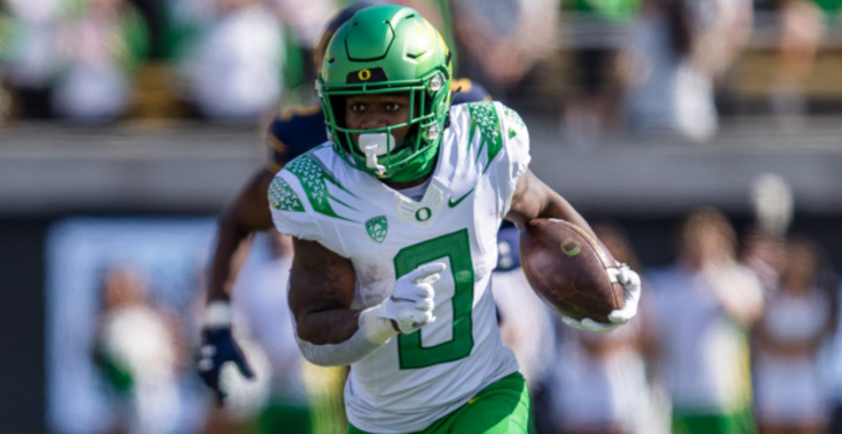 Oregon Ducks running back Bucky Irving on a rushing attempt during a college football game.