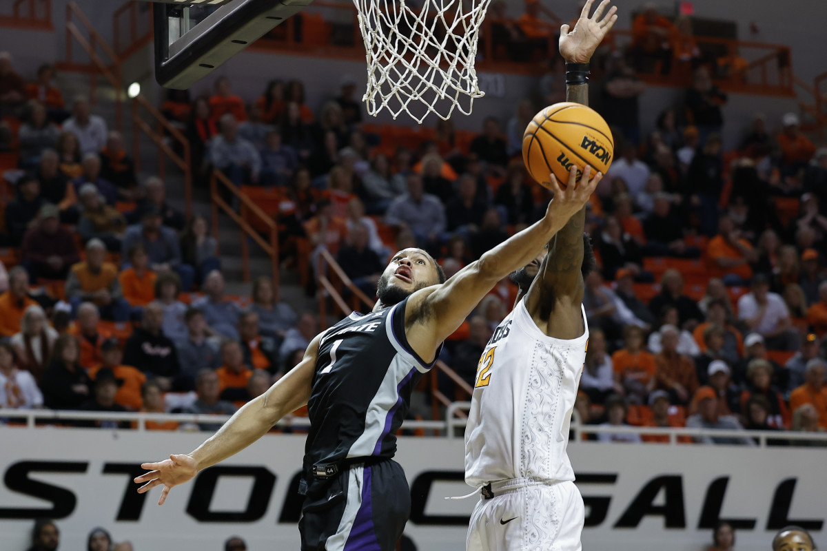 Kansas State Wildcats guard Markquis Nowell (1) goes up for a basket in front of Oklahoma State Cowboys forward Kalib Boone