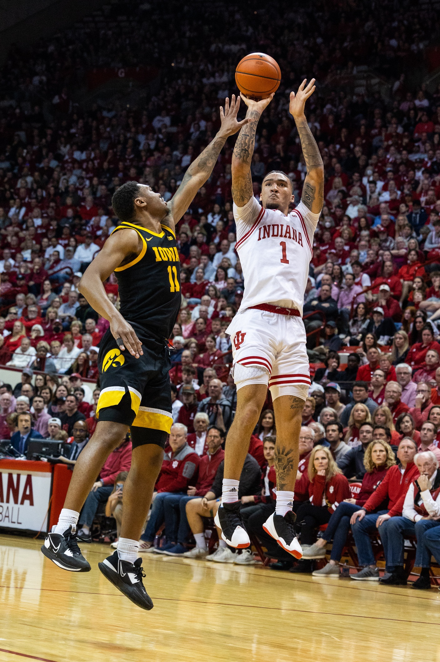 Indiana Hoosiers guard Jalen Hood-Schifino (1) shoots the ball while Iowa Hawkeyes guard Tony Perkins (11) defends in the first half at Simon Skjodt Assembly Hall.