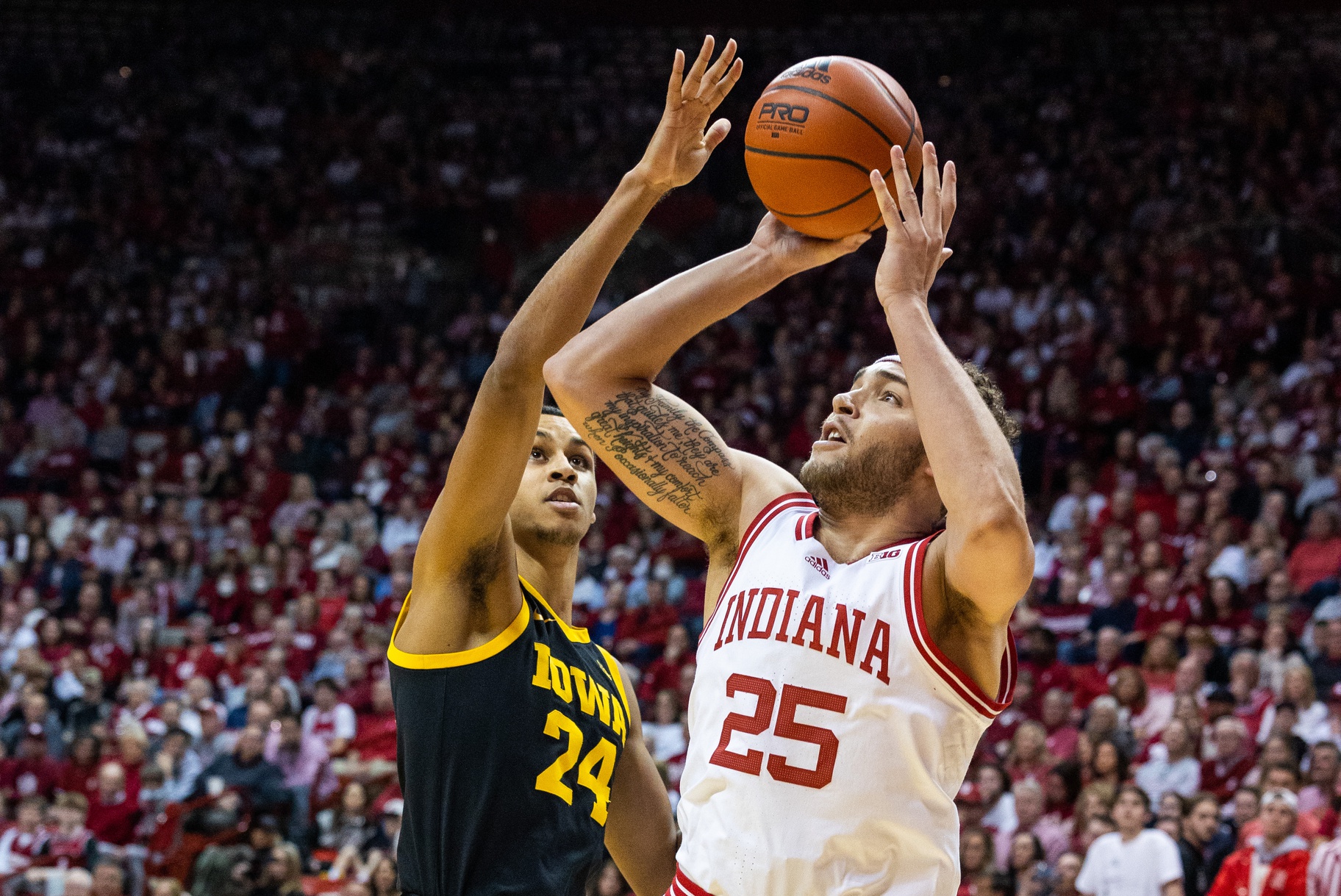 Indiana Hoosiers forward Race Thompson (25) shoots the ball while Iowa Hawkeyes forward Kris Murray (24) defends in the first half at Simon Skjodt Assembly Hall.