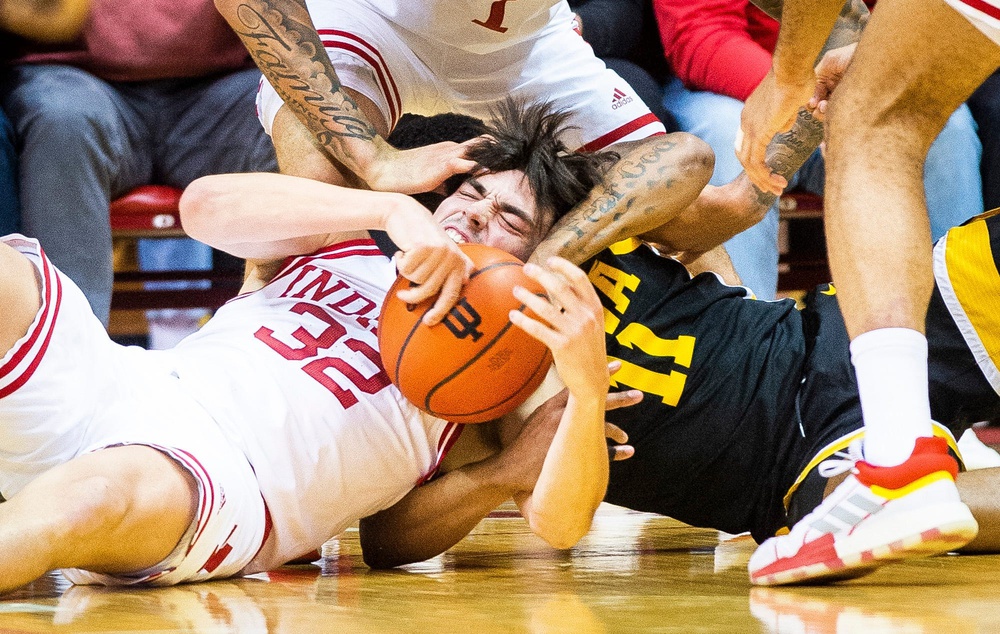 Indiana's Trey Galloway (32) fights with Iowa's Tony Perkins (11) for a loose ball during the first half of the Indiana versus Iowa men's basketball game at Simon Skjodt Assembly Hall.