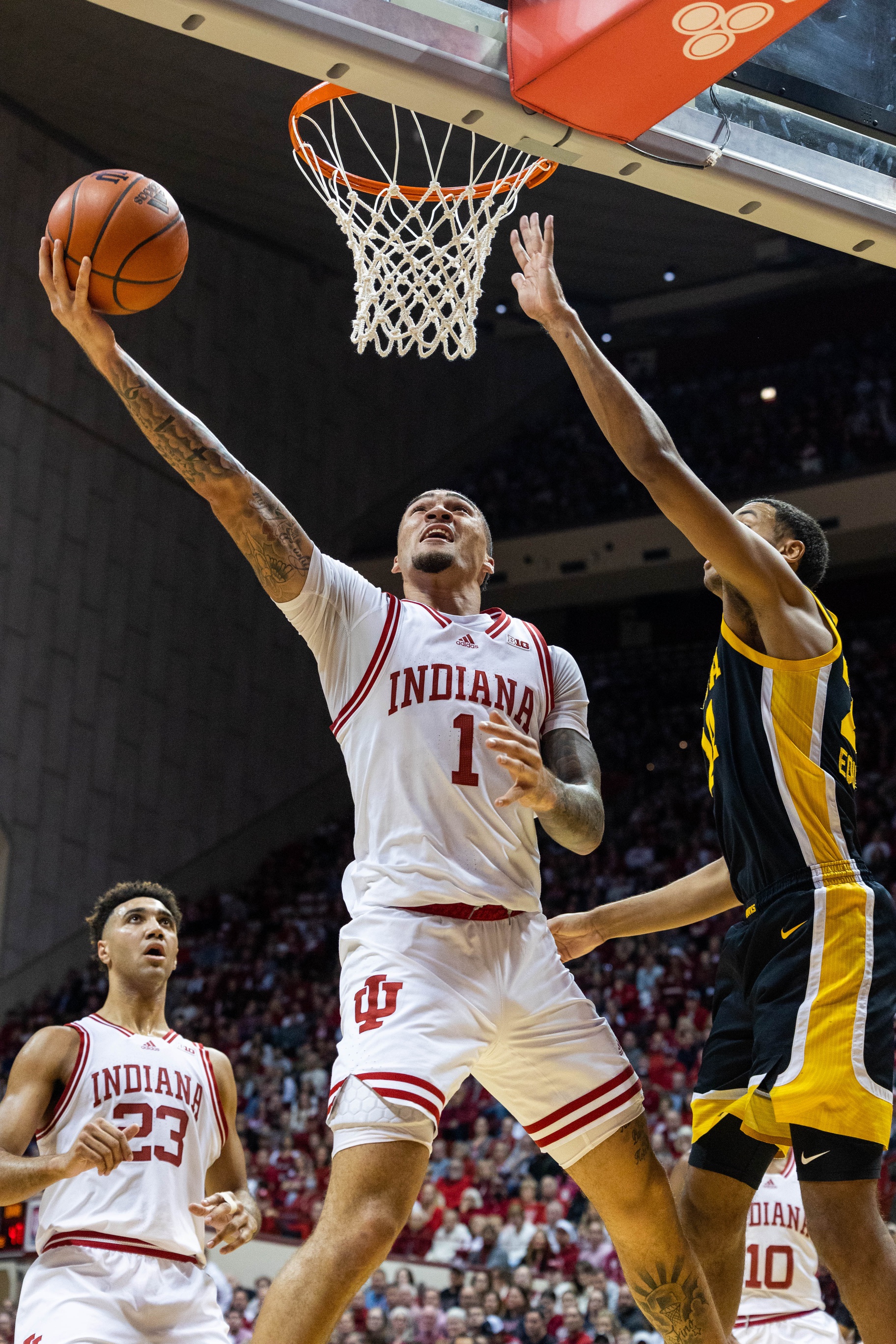 Indiana Hoosiers guard Jalen Hood-Schifino (1) shoots the ball while Iowa Hawkeyes forward Kris Murray (24) defends in the first half at Simon Skjodt Assembly Hall.