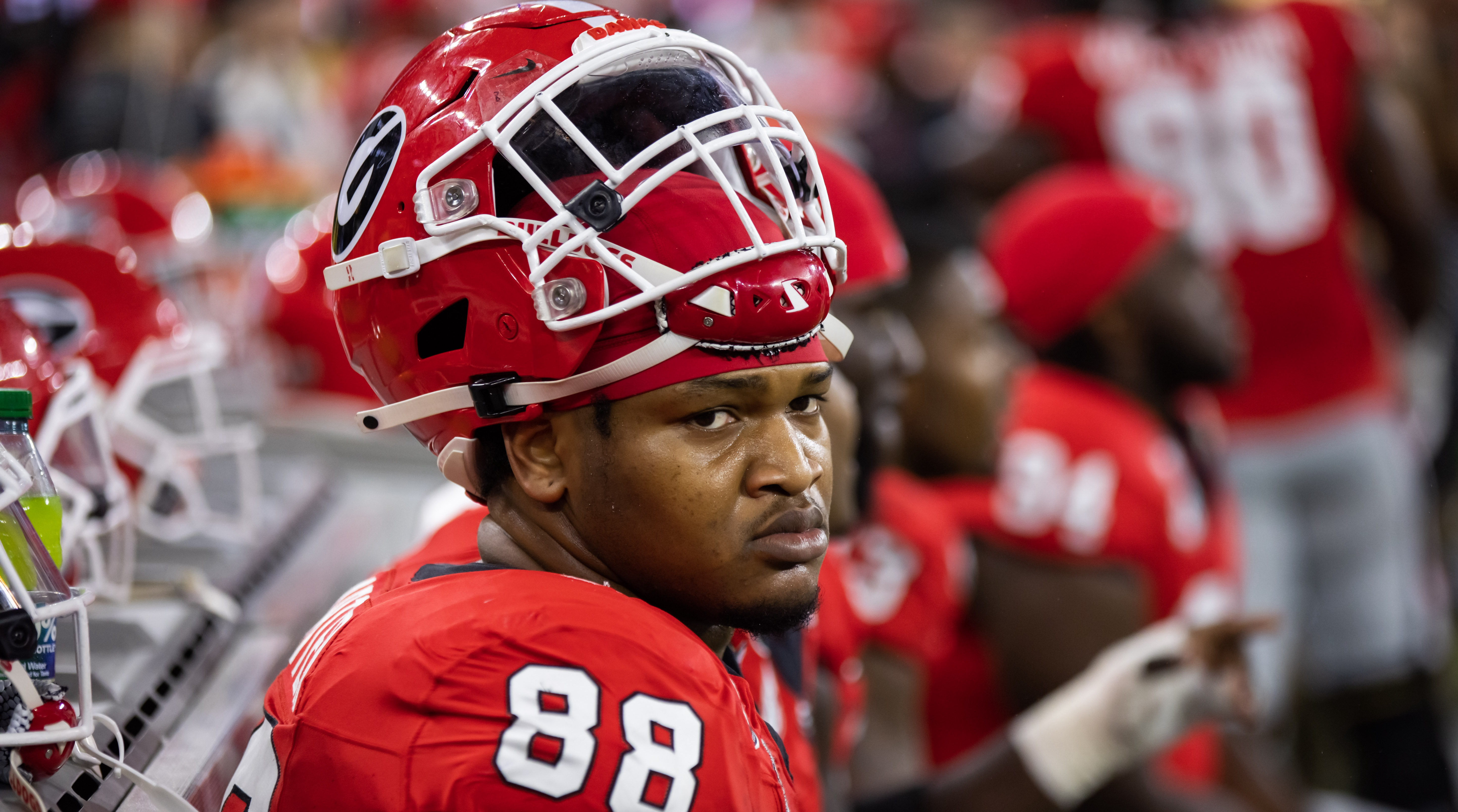 Georgia defensive lineman Jalen Carter sits on the sideline bench