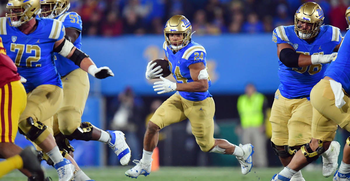 UCLA running back Zach Charbonnet carries the ball at the Rose Bowl against USC