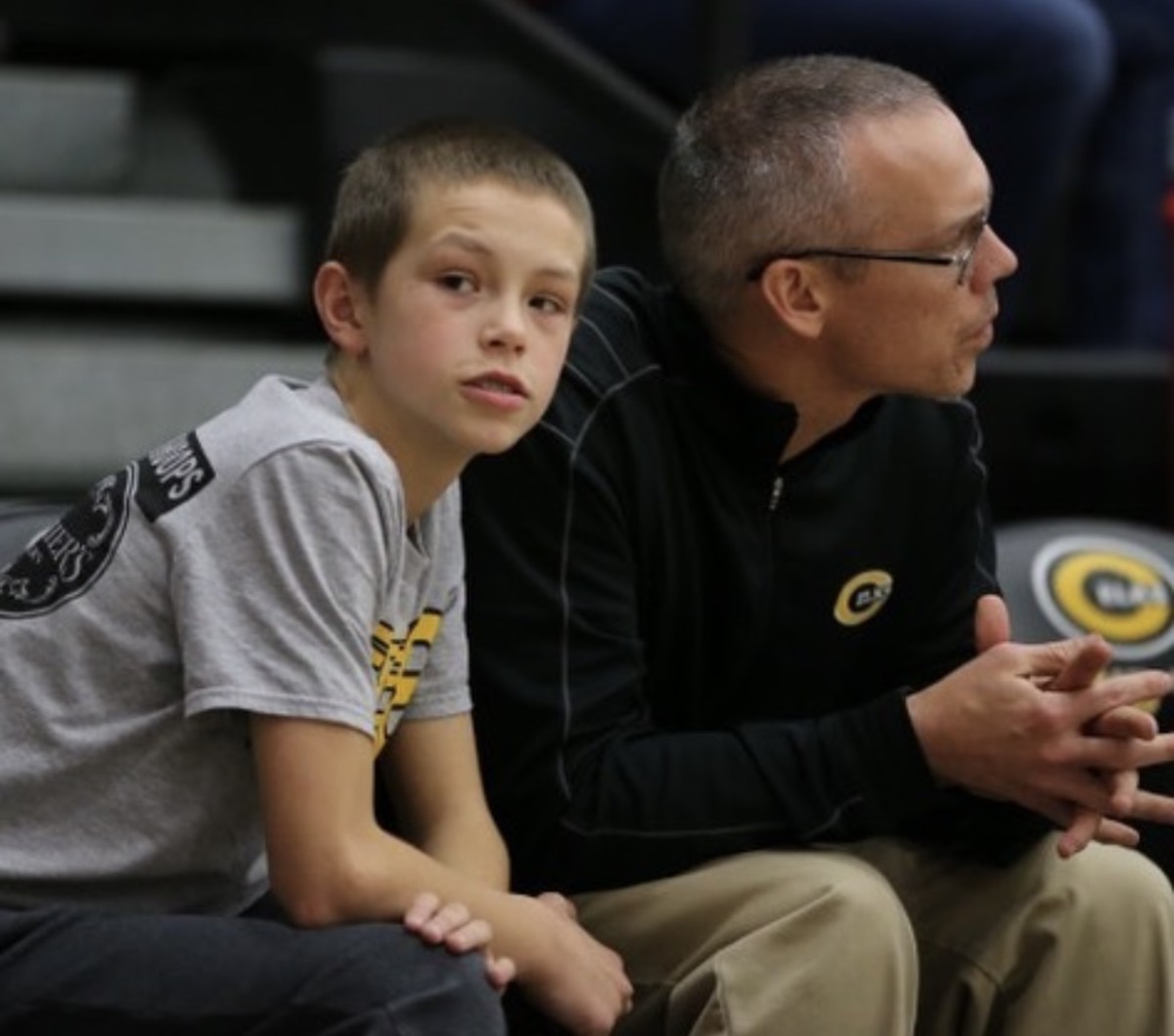 A younger Gabe Cupps (left) takes in a game with his father, Centerville head coach Brook Cupps (right).
