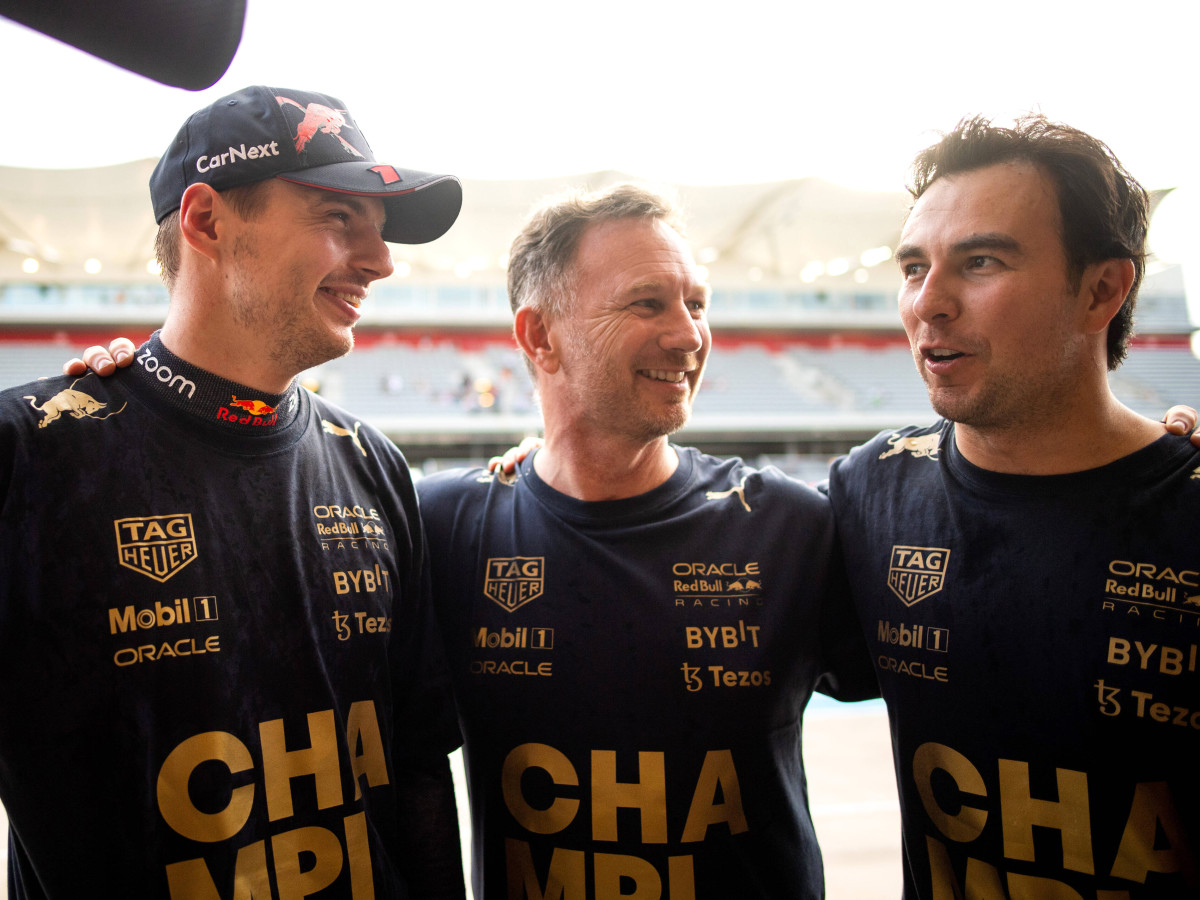 Red Bull drivers Max Verstappen and Sergio Perez celebrate with team principal Christian Horner after winning the the Constructors World Championship.