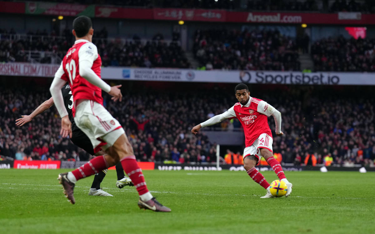 Reiss Nelson pictured (right) shooting to score a 97th-minute winner for Arsenal against Bournemouth in March 2023