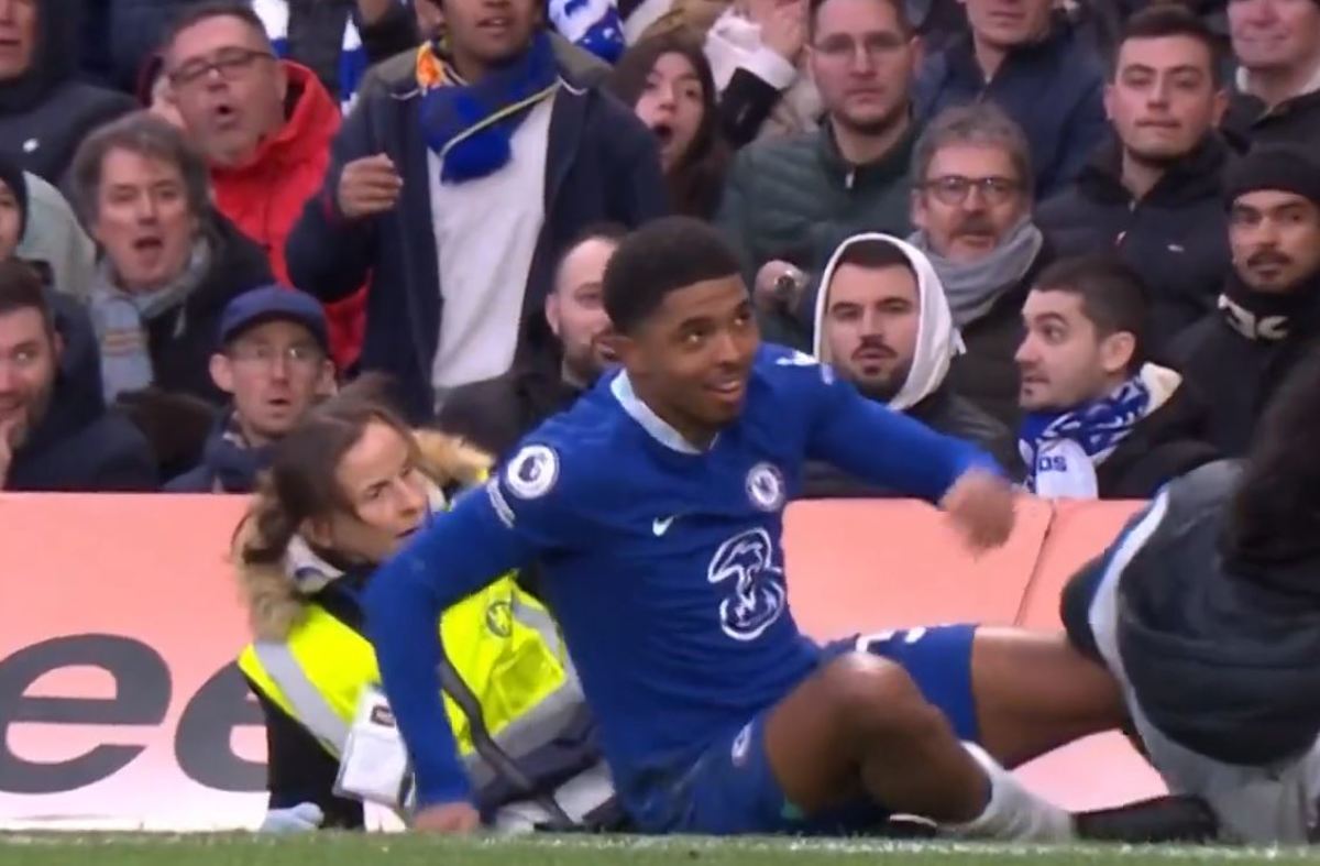 Chelsea defender Wesley Fofana pictured (center) after accidentally knocking over a security steward (left) at Stamford Bridge during an EPL game against Leeds in March 2023