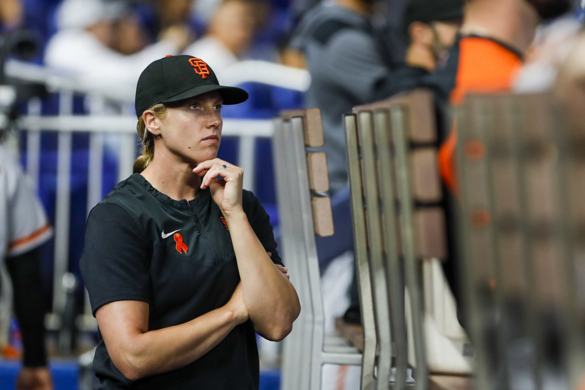 SF Giants assistant coach Alyssa Nakken (92) watches from the dugout prior to the game against the Miami Marlins. (2022)
