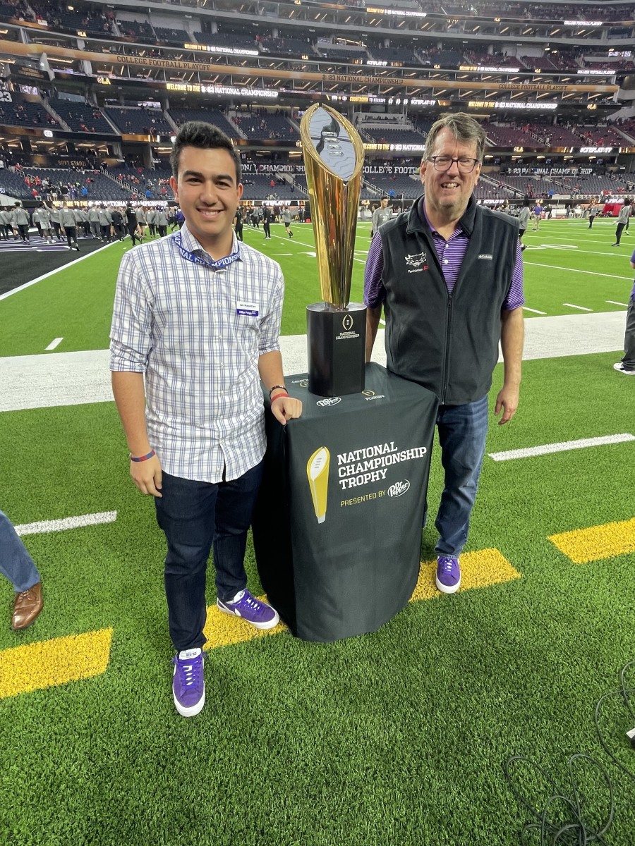 Ian Napetian and Barry Lewis at the National Championship football game in January. 