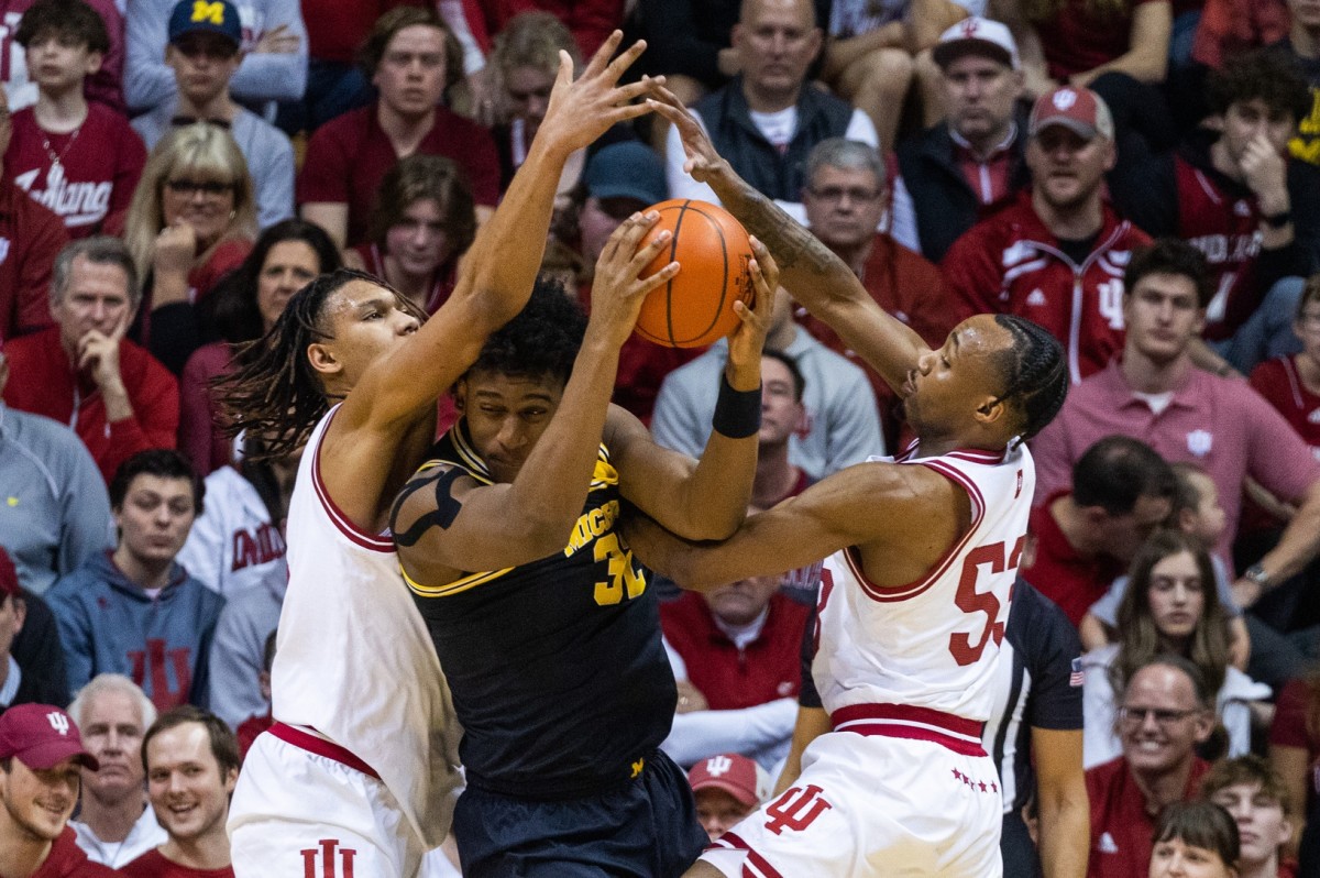 Michigan Wolverines forward Tarris Reed Jr. (32) looks to pass the ball while Indiana Hoosiers forward Malik Reneau (5) and guard Tamar Bates (53) defend in the first half at Simon Skjodt Assembly Hall.