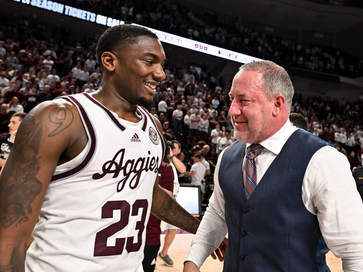 Texas A&M coach Buzz Williams and guard Tyrece Radford  embrace after a win against the Alabama.