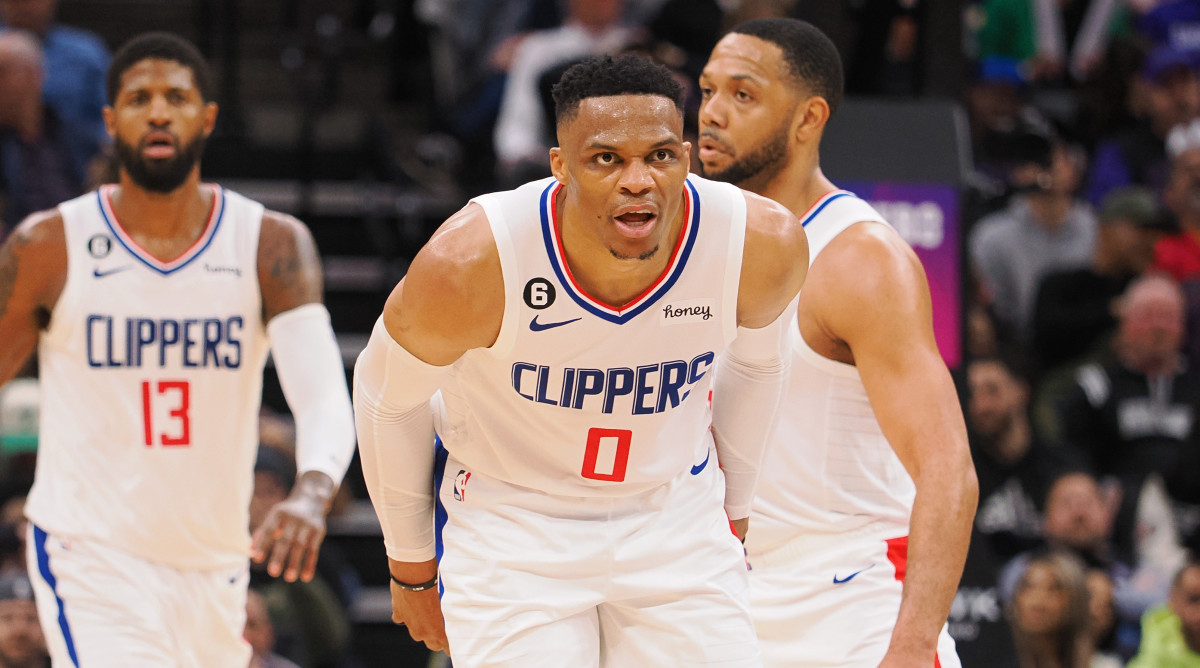 Clippers guard Russeel Westbrook snarls with teammate Paul George in the background