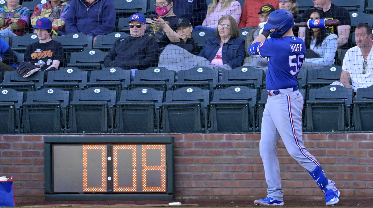 Rangers catcher Sam Huff waits in the batting circle as the pitch timer winds down in the background