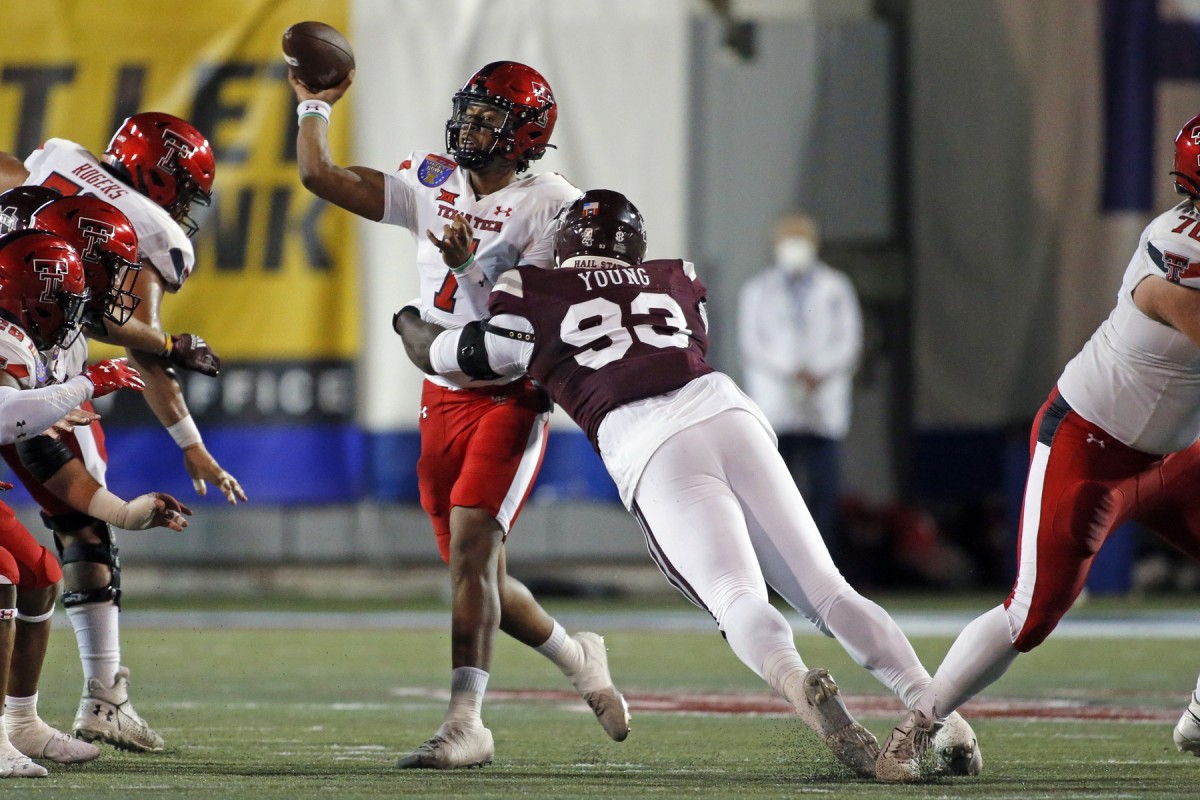 Dec 28, 2021; Memphis, TN, USA; Texas Tech Red Raiders quarterback Donovan Smith (7) passes the ball as Mississippi State Bulldogs defensive linemen Cameron Young (93) rushes the pass during the first half at Liberty Bowl Stadium. Mandatory Credit: Petre Thomas-USA TODAY Sports