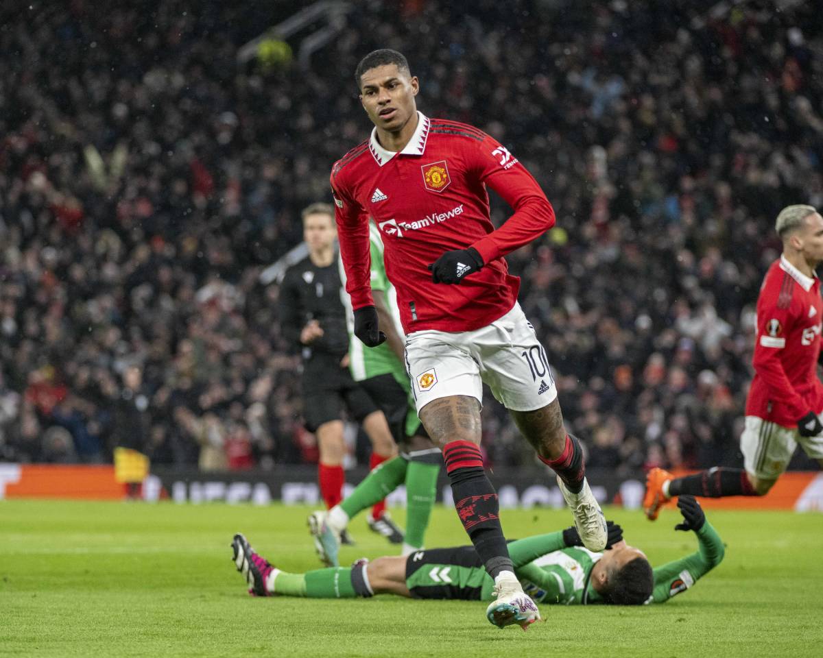 Marcus Rashford pictured celebrating after scoring for Manchester United against Real Betis in the 2022/23 UEFA Europa League round of 16 at Old Trafford