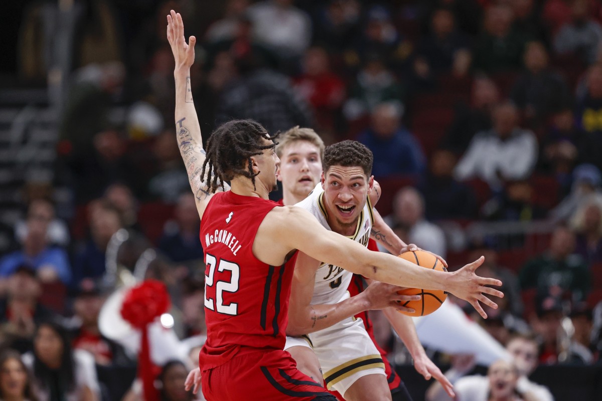 Purdue Boilermakers forward Mason Gillis (0) is defended by Rutgers Scarlet Knights guard Caleb McConnell (22) during the first half at United Center.