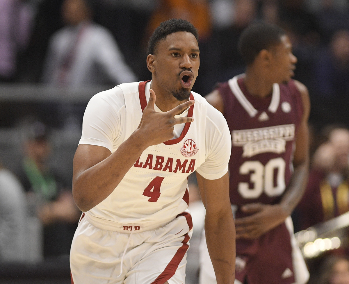 Alabama Crimson Tide forward Noah Gurley (4) celebrates a three point basket against the Mississippi State Bulldogs during the first half at Bridgestone Arena.