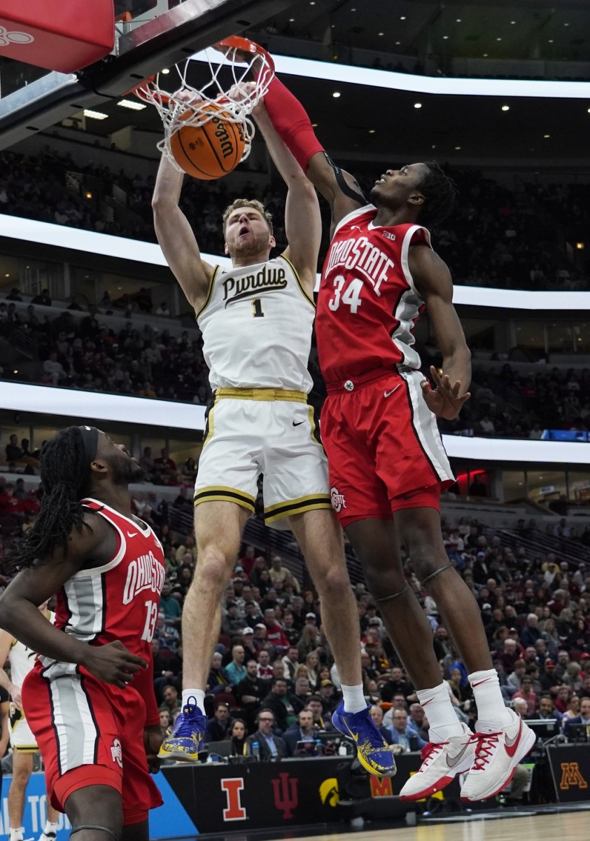 Purdue Boilermakers forward Caleb Furst (1) dunks the ball on Ohio State Buckeyes center Felix Okpara (34) during the first half at United Center.
