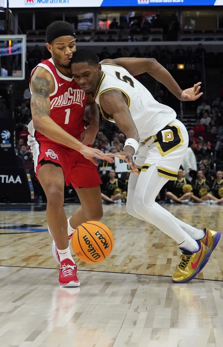 Buckeyes guard Roddy Gayle Jr. (1) and Purdue Boilermakers guard Brandon Newman (5) go for the ball during the first half at United Center.