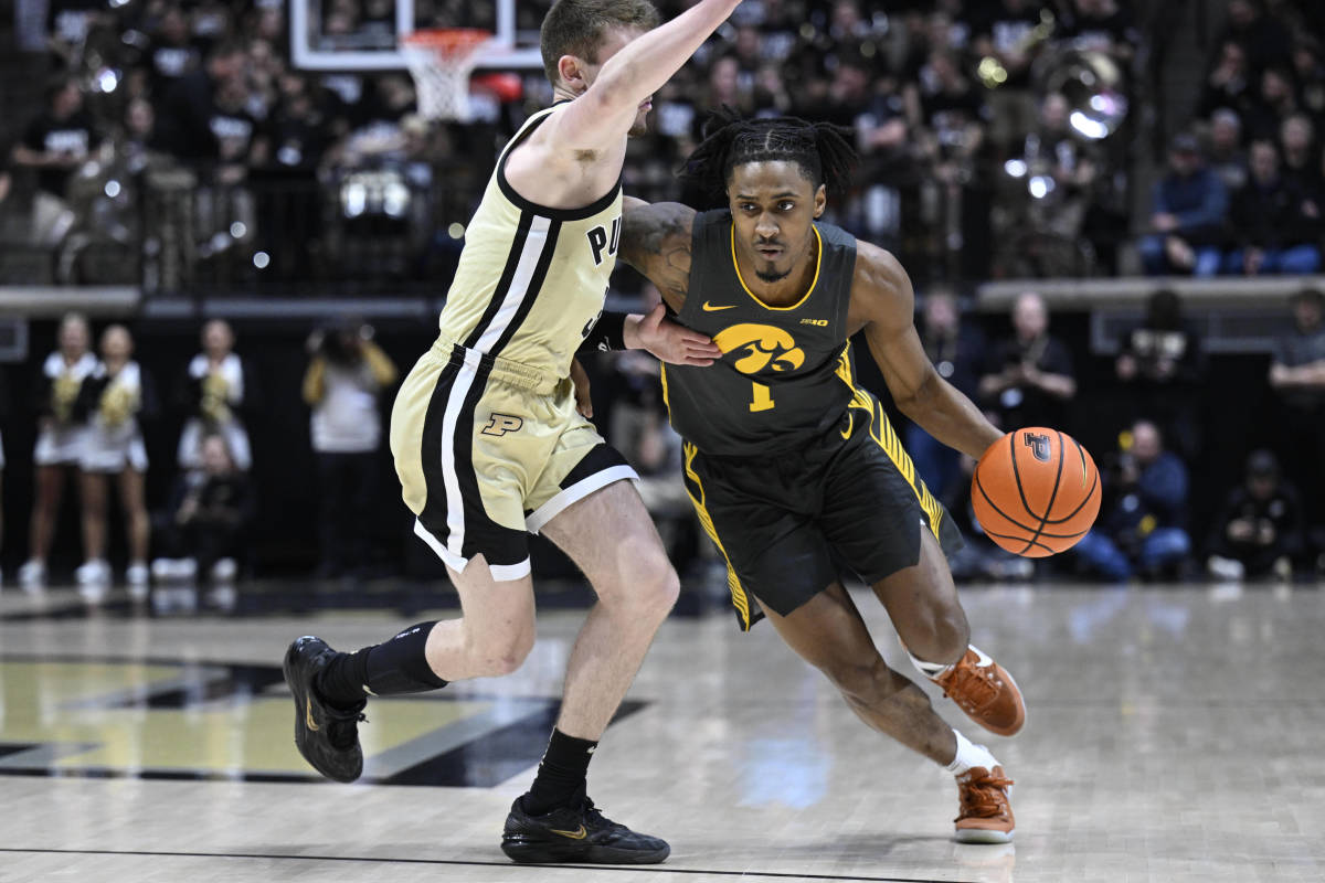 Feb 9, 2023; West Lafayette, Indiana, USA; Iowa Hawkeyes guard Ahron Ulis (1) drives the ball around Purdue Boilermakers guard Braden Smith (3) during the first half at Mackey Arena. Mandatory Credit: Marc Lebryk-USA TODAY Sports