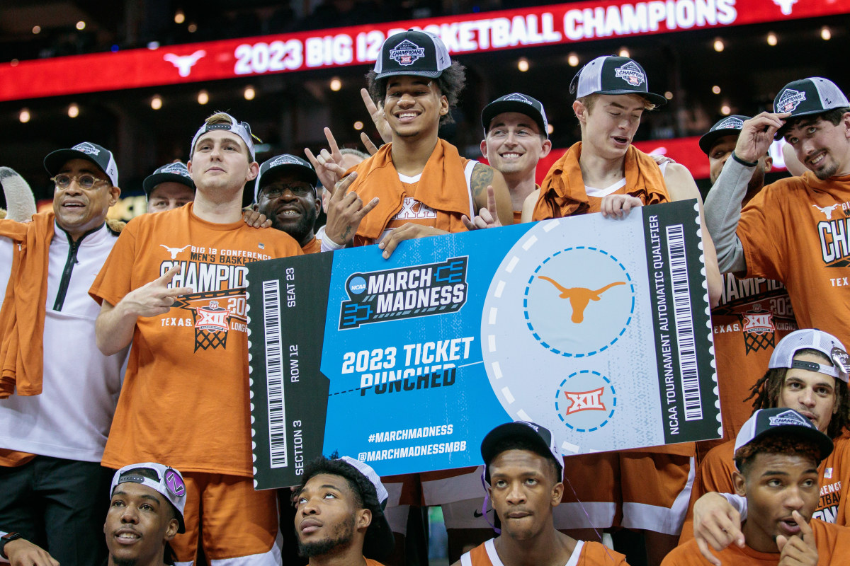 Texas Longhorns players hold up the ticket to the NCAA tournament after the game