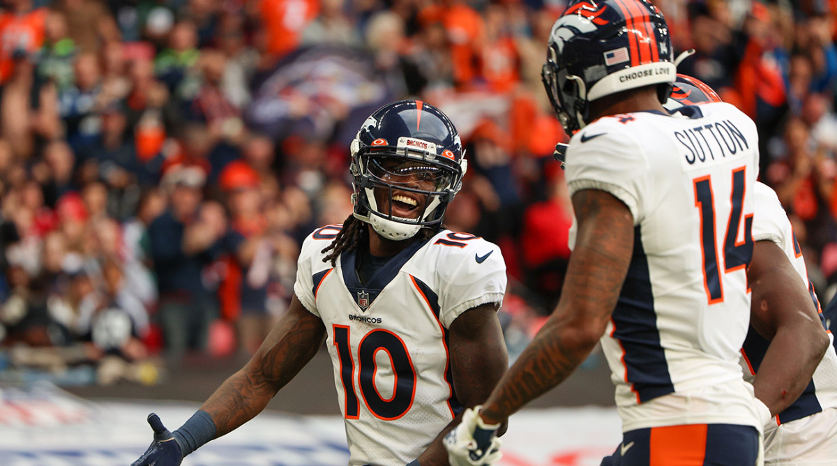 Broncos wide receiver Jerry Jeudy (10) is congratulated by wide receiver Courtland Sutton (14) after scoring a touchdown.