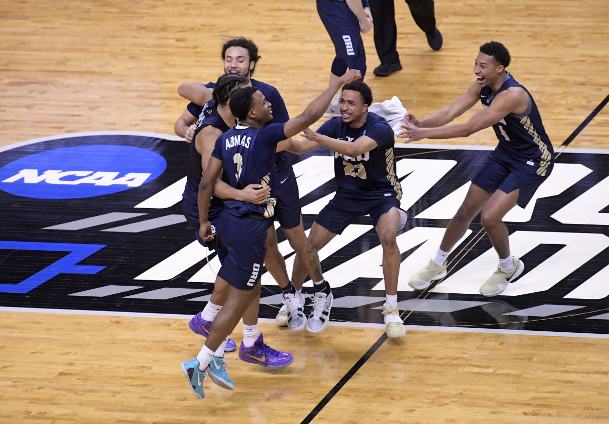 Oral Roberts players jump and reach for each other on the court after a win