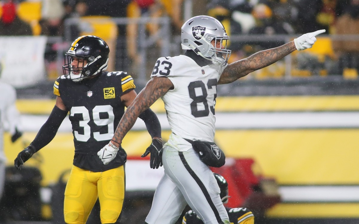 Las Vegas Raiders Darren Waller (83) signals for a first down as Pittsburgh Steelers Minkah Fitzpatrick (39) says it was incomplete during the first half at Acrisure Stadium in Pittsburgh, PA on December 24, 2022.