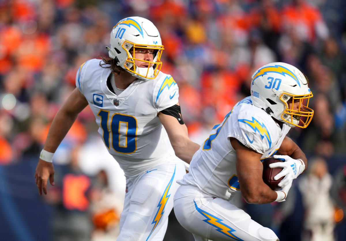 Los Angeles Chargers quarterback Justin Herbert hands off the ball to running back Austin Ekeler