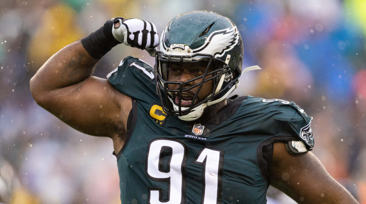 Eagles defensive tackle Fletcher Cox flexes after sacking Trevor Lawrence in a game.