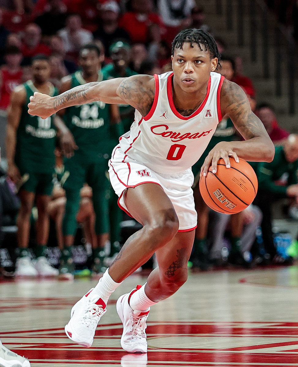 Marcus Sasser drives the ball up court for Houston.