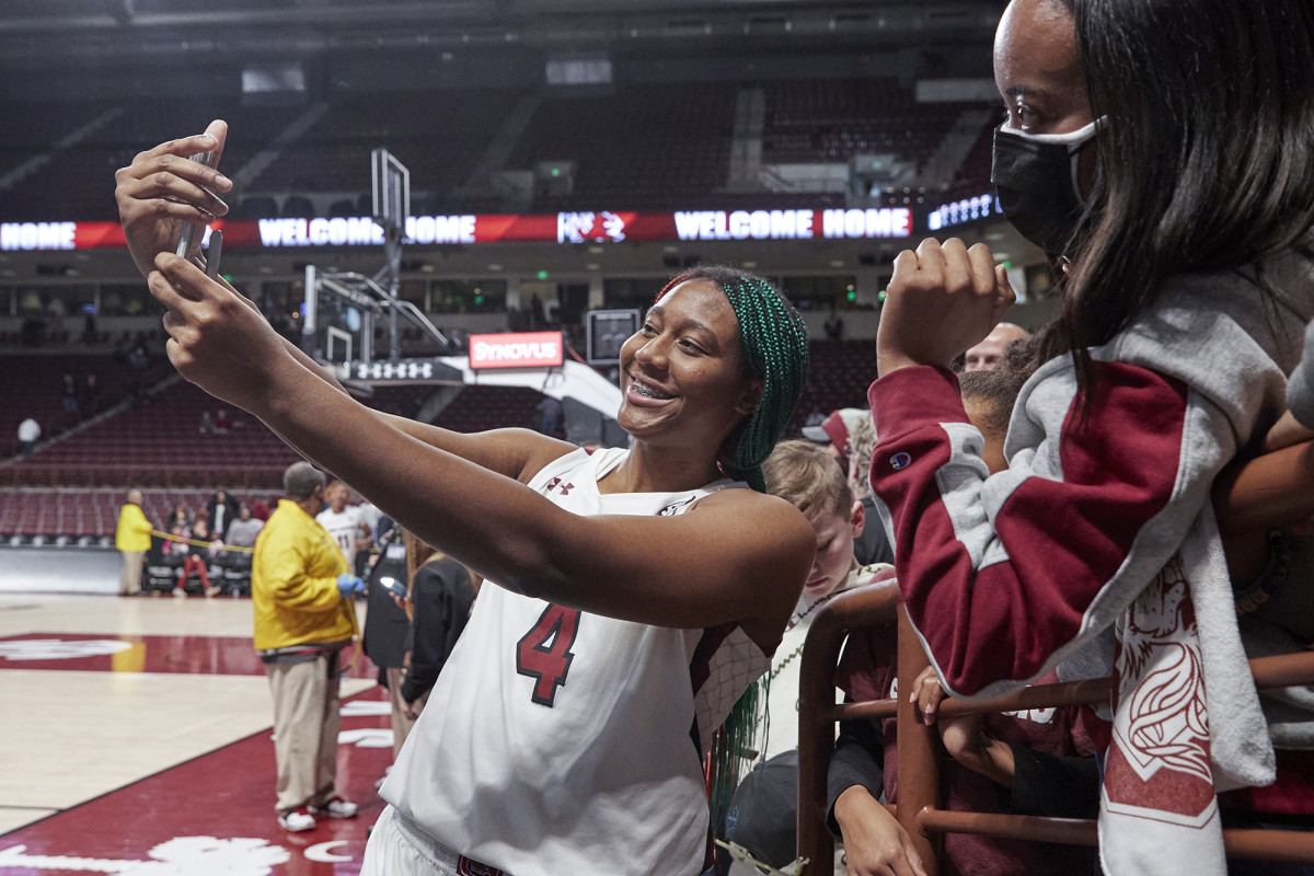 South Carolina star Aliyah Boston takes a selfie with a Gamecocks fan.