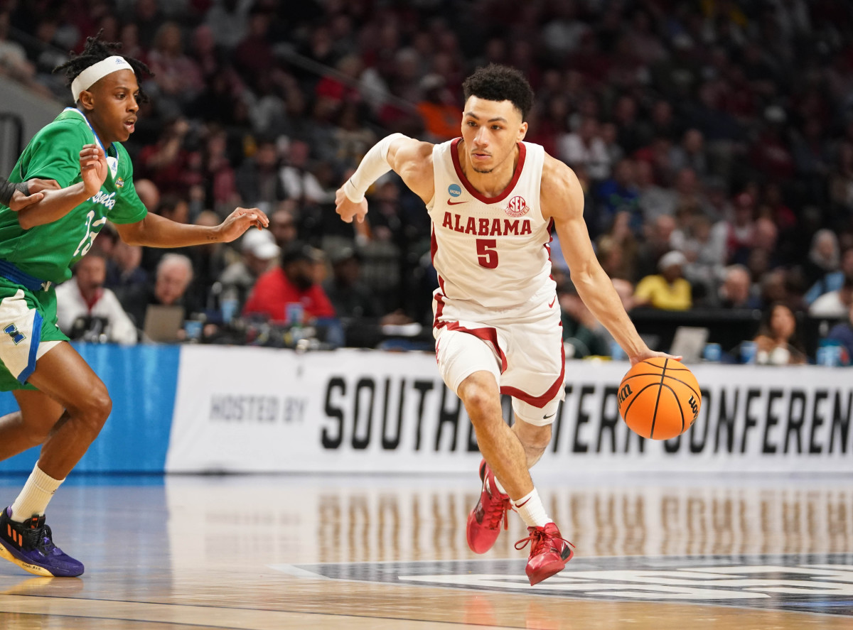 Mar 16, 2023; Birmingham, AL, USA; Alabama Crimson Tide guard Jahvon Quinerly (5) dribbles against Texas A&M-CC Islanders guard Ross Williams (23) during the first half in the first round of the 2023 NCAA Tournament at Legacy Arena. Mandatory Credit: Marvin Gentry-USA TODAY Sports