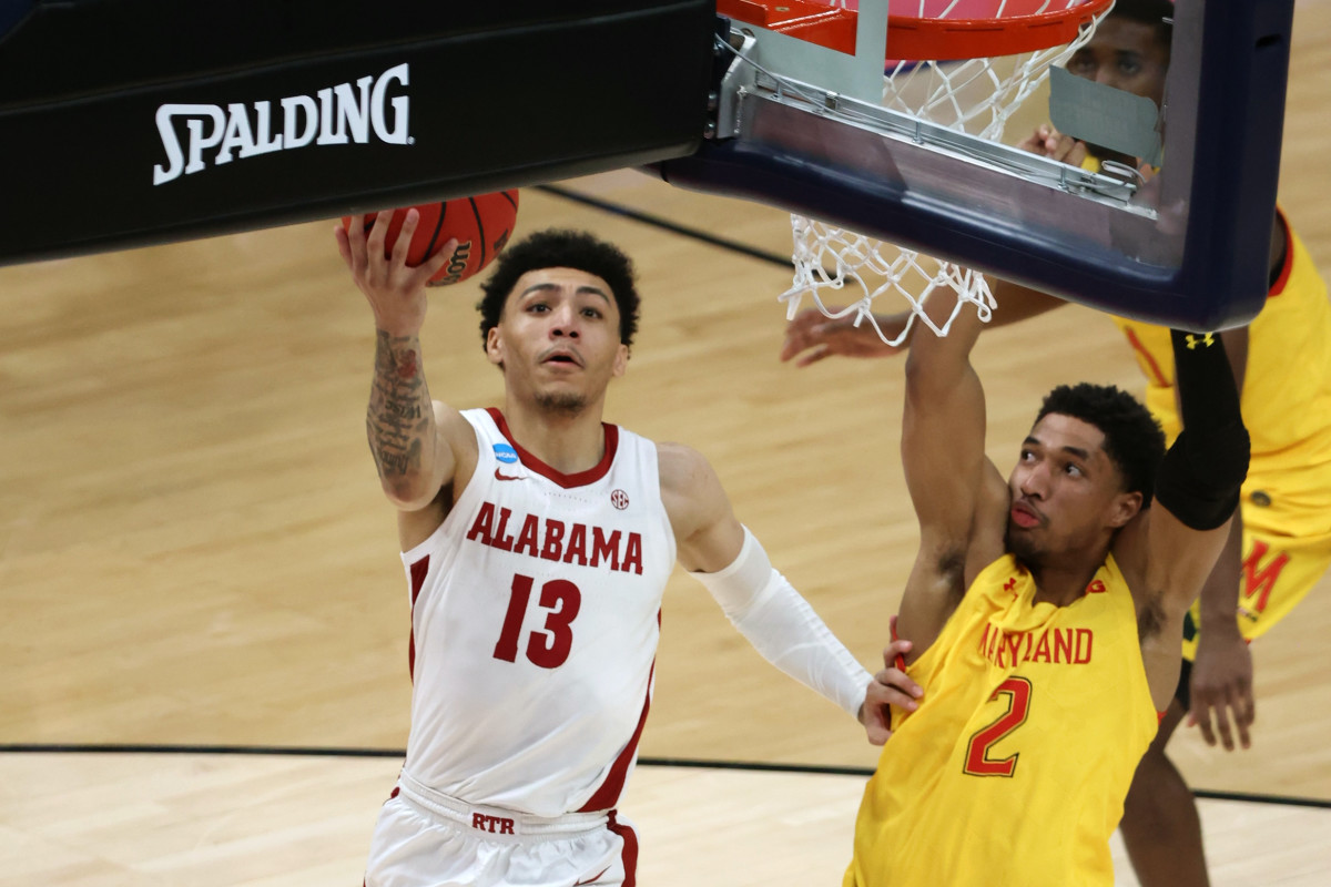 Alabama Crimson Tide guard Jahvon Quinerly (13) shoots against Maryland Terrapins guard Aaron Wiggins (2) in the second half in the second round of the 2021 NCAA Tournament at Bankers Life Fieldhouse.