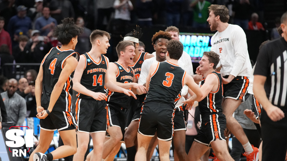 Princeton Tigers players jump in a circle and celebrate the victory