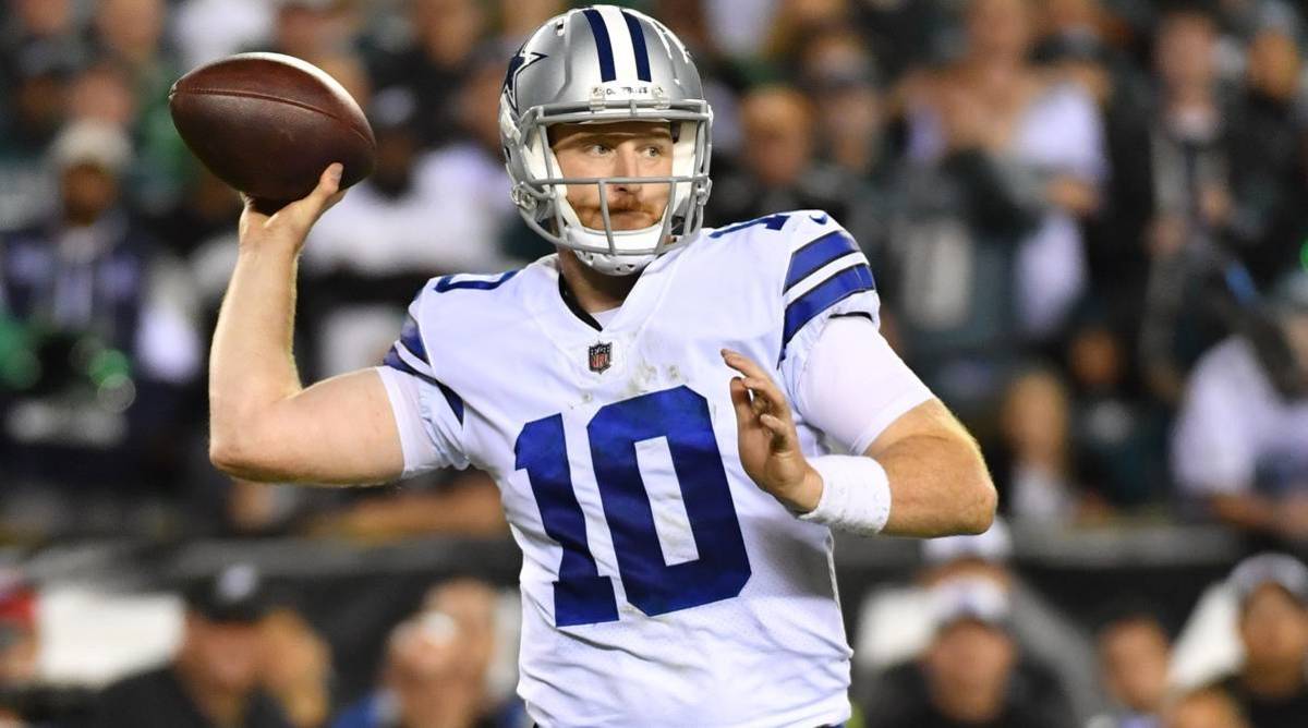 Cowboys quarterback Cooper Rush throws a pass in a game.