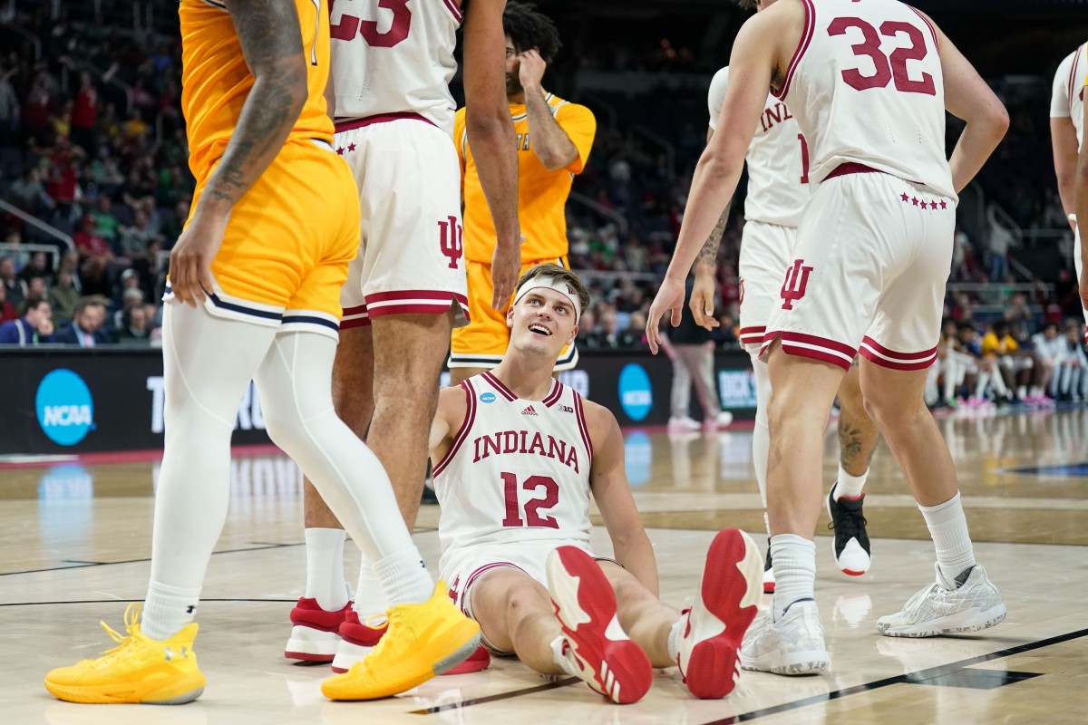 Indiana forward Miller Kopp smiles at teammate Trayce Jackson-Davis from the floor after getting fouled. He wore a headband for the first time on Friday, and scored 13 points in an Indiana victory over Kent State. (USA TODAY Sports)