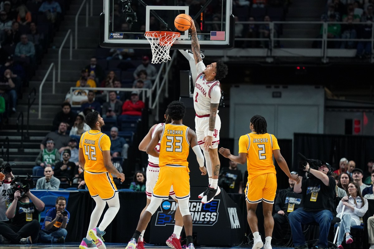 Indiana Hoosiers guard Jalen Hood-Schifino (1) dunks the ball as Kent State Golden Flashes center Cli'Ron Hornbeak (42) and forward Malik Reneau (5) and forward Miryne Thomas (33) and guard Malique Jacobs (2) look on in the first half at MVP Arena.